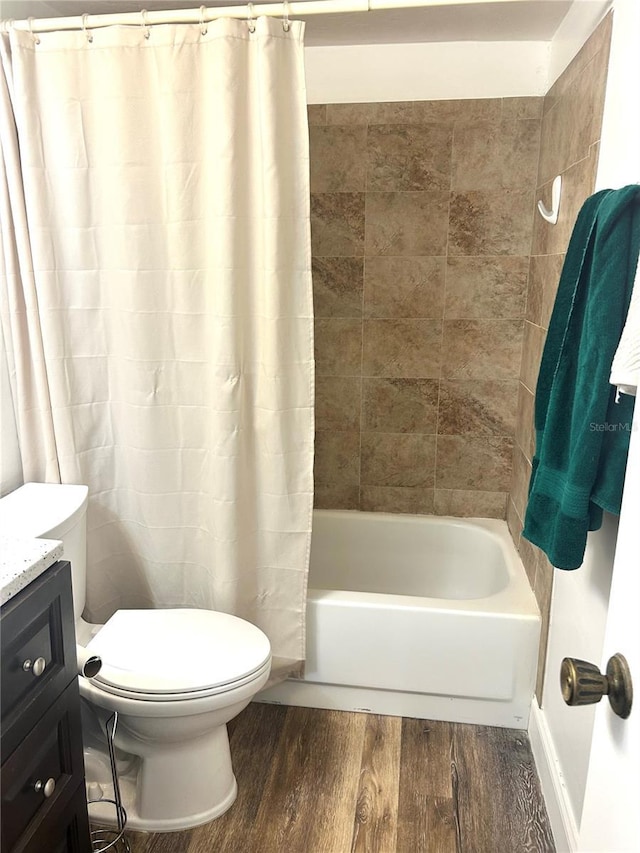 2715 NW 104th Ct Unit 1, Gainesville, FL 32606 - bathroom featuring wood finished floors, toilet, shower / bath combination with curtain, and vanity