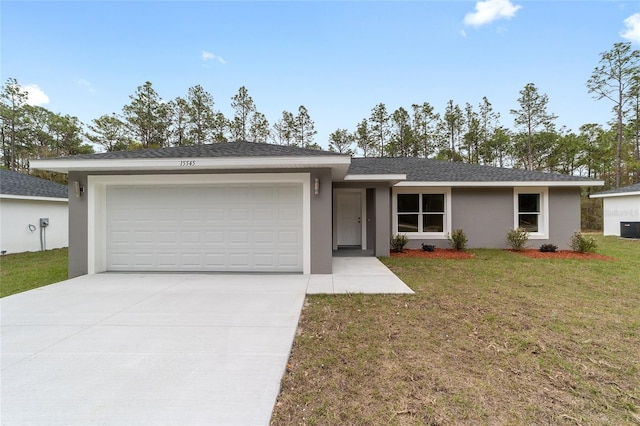 ranch-style home featuring an attached garage, stucco siding, driveway, a front yard, and central AC