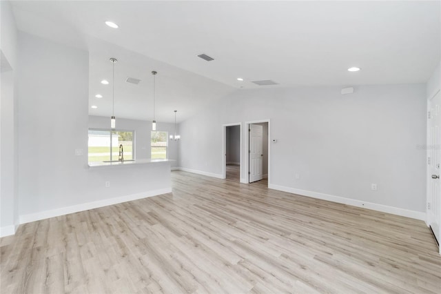empty room with vaulted ceiling, light wood-style flooring, a sink, recessed lighting, and baseboards
