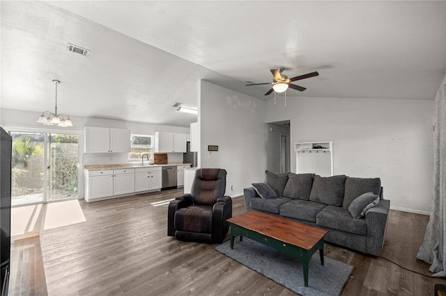 9 Juniper Pass Trl, Ocala, FL 34480 - living area with vaulted ceiling, a chandelier, a ceiling fan, wood finished floors, and baseboards