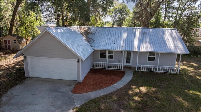 9 Juniper Pass Trl, Ocala, FL 34480 - view of front of property with a garage, concrete driveway, metal roof, and covered porch