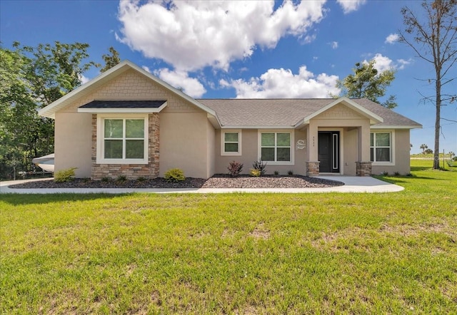ranch-style home featuring stone siding, a front yard, a shingled roof, and stucco siding