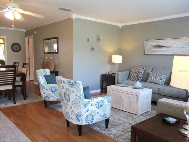 13762 SW 112th Ter, Dunnellon, FL 34432 - living room with wood finished floors, crown molding, a ceiling fan, and baseboards