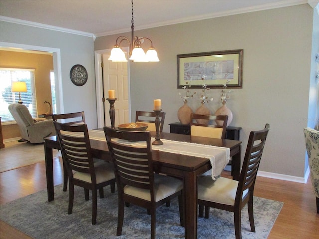 13762 SW 112th Ter, Dunnellon, FL 34432 - dining area featuring wood finished floors, baseboards, ornamental molding, and a chandelier