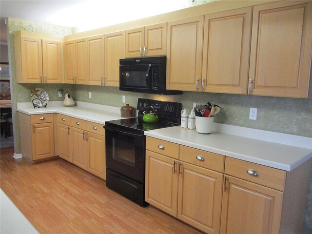 13762 SW 112th Ter, Dunnellon, FL 34432 - kitchen with black appliances, light brown cabinets, light wood-style flooring, and light countertops