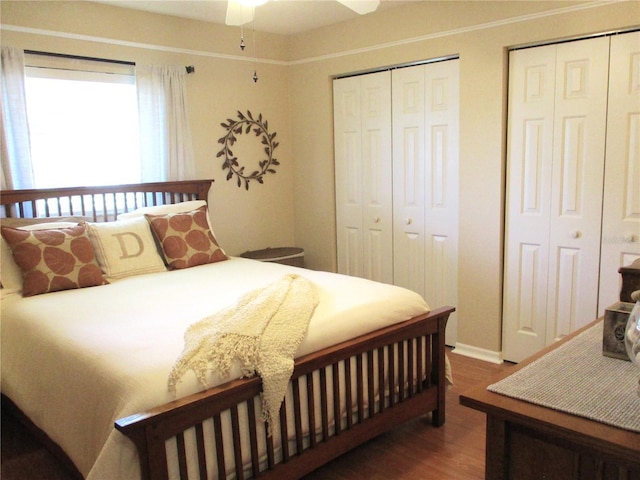 13762 SW 112th Ter, Dunnellon, FL 34432 - bedroom featuring two closets, wood finished floors, and ceiling fan