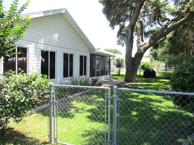13762 SW 112th Ter, Dunnellon, FL 34432 - rear view of property with a gate and a sunroom
