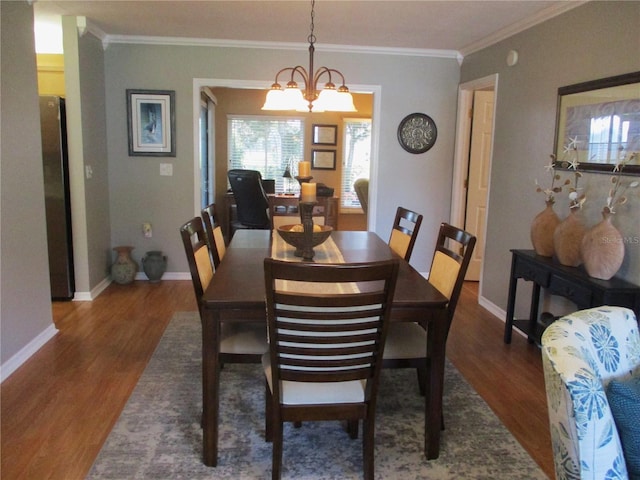 13762 SW 112th Ter, Dunnellon, FL 34432 - dining area with wood finished floors, ornamental molding, baseboards, and a chandelier