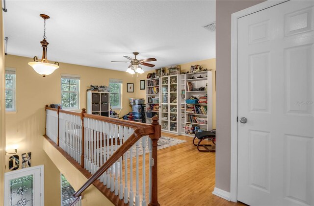 9709 E Baymeadows Dr, Inverness, FL 34450 - hallway featuring an upstairs landing and wood finished floors