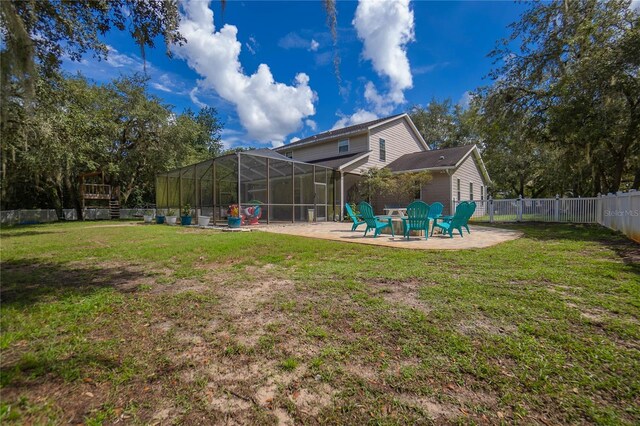 9709 E Baymeadows Dr, Inverness, FL 34450 - rear view of house with a patio area, a fire pit, and glass enclosure