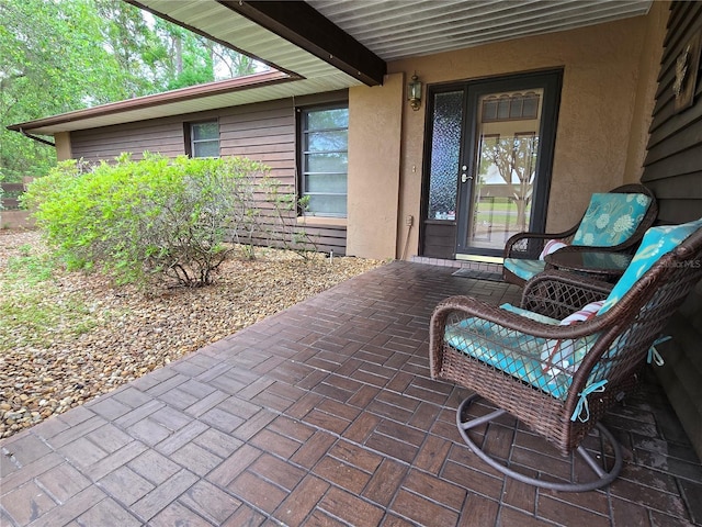 doorway to property featuring stucco siding