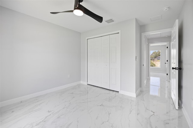 3079 SW 168th Loop, Ocala, FL 34473 - unfurnished bedroom featuring attic access, light marble finish floors, a closet, and a ceiling fan