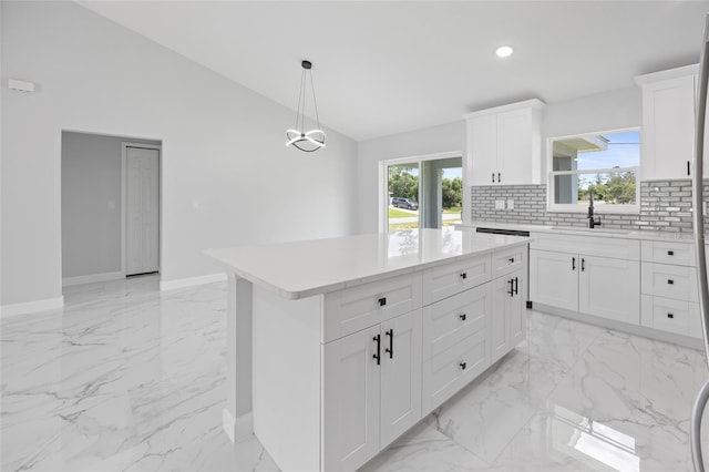 3079 SW 168th Loop, Ocala, FL 34473 - kitchen with light marble finish floors, vaulted ceiling, decorative backsplash, light countertops, and recessed lighting
