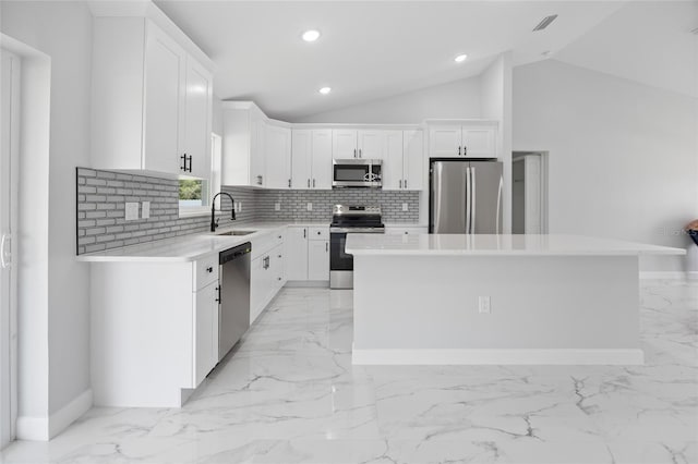 3079 SW 168th Loop, Ocala, FL 34473 - kitchen with stainless steel appliances, light marble finish flooring, a kitchen island, backsplash, and lofted ceiling