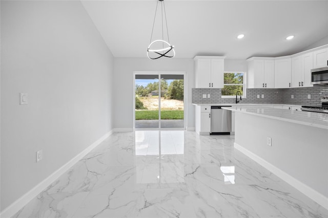 3079 SW 168th Loop, Ocala, FL 34473 - kitchen featuring stainless steel appliances, light marble finish flooring, decorative backsplash, white cabinetry, and recessed lighting