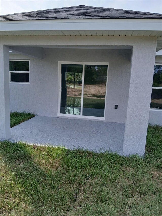 3079 SW 168th Loop, Ocala, FL 34473 - view of property exterior featuring roof with shingles and stucco siding