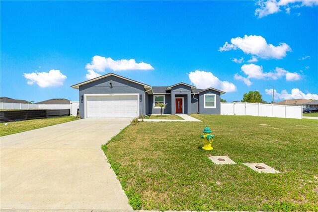 10291 SE 67th Ter, Belleview, FL 34420 - ranch-style home featuring concrete driveway, an attached garage, and stucco siding