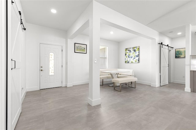 10291 SE 67th Ter, Belleview, FL 34420 - foyer entrance featuring a barn door, baseboards, recessed lighting, and finished concrete floors