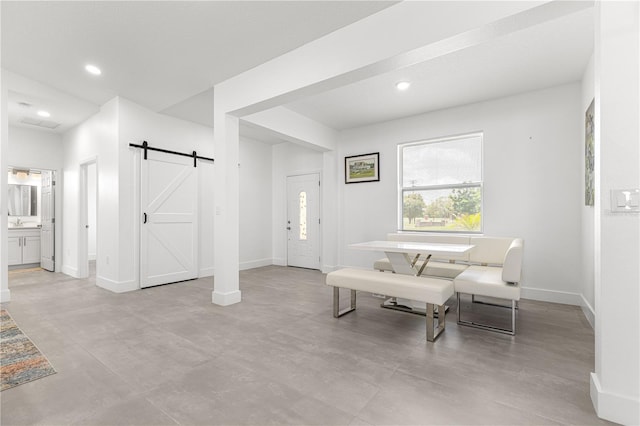 10291 SE 67th Ter, Belleview, FL 34420 - living area with a barn door, baseboards, recessed lighting, and finished concrete flooring