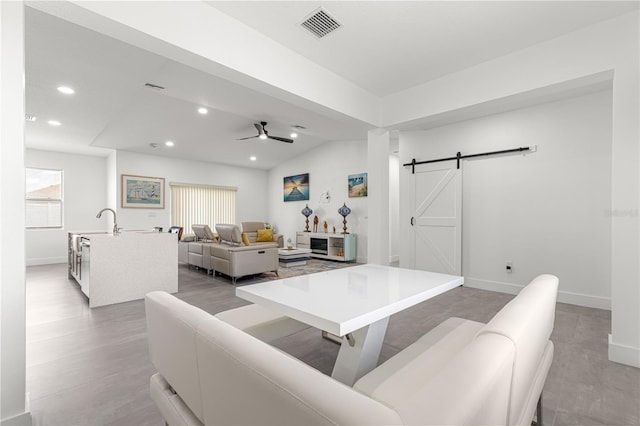 10291 SE 67th Ter, Belleview, FL 34420 - living room featuring a barn door, recessed lighting, baseboards, ceiling fan, and light wood finished floors