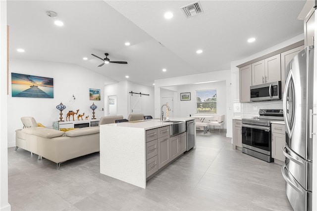10291 SE 67th Ter, Belleview, FL 34420 - kitchen featuring stainless steel appliances, a sink, a barn door, gray cabinets, and open floor plan