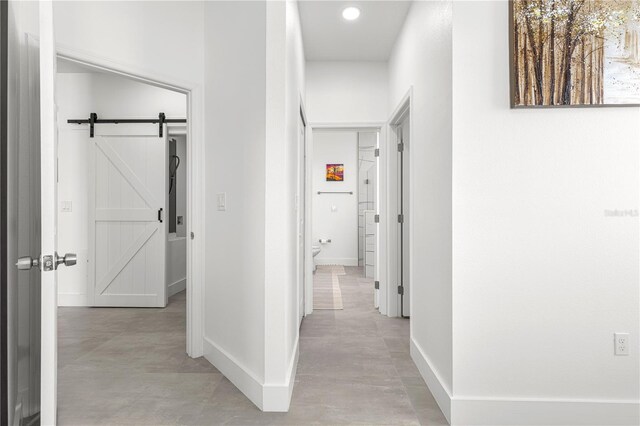 10291 SE 67th Ter, Belleview, FL 34420 - hallway with a barn door, baseboards, and recessed lighting