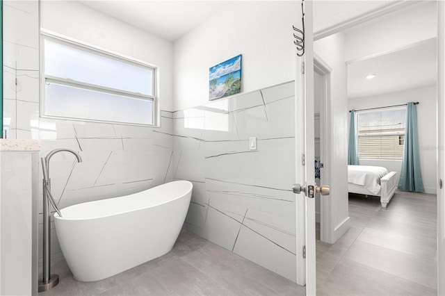 10291 SE 67th Ter, Belleview, FL 34420 - ensuite bathroom with tile walls and a freestanding bath
