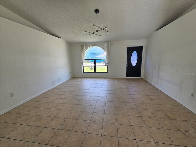 6 Bahia Trace Loop, Ocala, FL 34472 - unfurnished room with a textured ceiling, a chandelier, light tile patterned floors, and baseboards