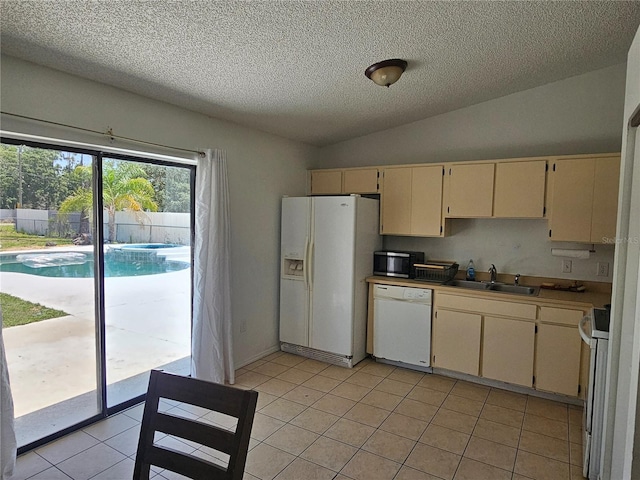 6 Bahia Trace Loop, Ocala, FL 34472 - kitchen featuring white appliances, cream cabinets, a sink, a textured ceiling, and light tile patterned flooring