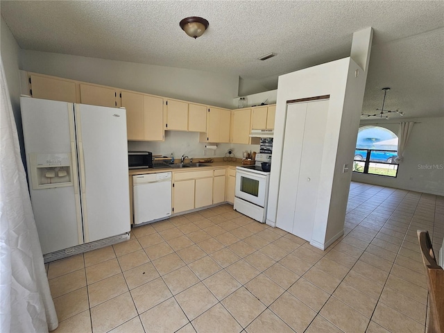 6 Bahia Trace Loop, Ocala, FL 34472 - kitchen with white appliances, a textured ceiling, lofted ceiling, a sink, and cream cabinets