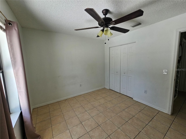 6 Bahia Trace Loop, Ocala, FL 34472 - unfurnished bedroom with light tile patterned floors, a textured ceiling, a closet, ceiling fan, and baseboards