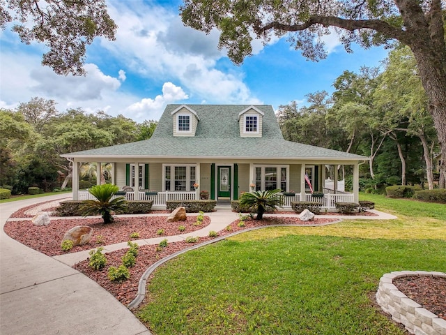1374 N Circus Ter, Hernando, FL 34442 - country-style home with a porch, a front yard, and a shingled roof