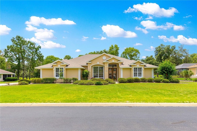 28 Golf View Dr, Ocala, FL 34472 - ranch-style home with stucco siding, a front lawn, and french doors