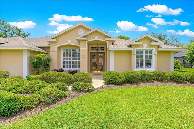 28 Golf View Dr, Ocala, FL 34472 - view of front of property with french doors, a front lawn, stucco siding, and roof with shingles