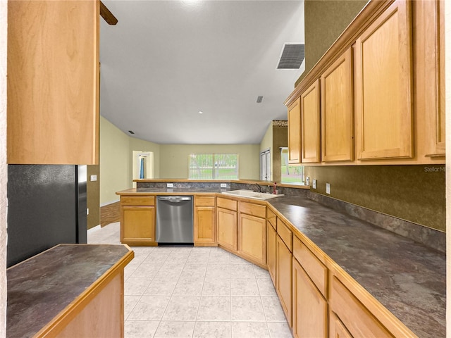 28 Golf View Dr, Ocala, FL 34472 - kitchen featuring dishwasher, dark countertops, a sink, light tile patterned floors, and a peninsula