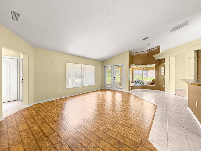 28 Golf View Dr, Ocala, FL 34472 - unfurnished living room with vaulted ceiling, light wood finished floors, french doors, and baseboards