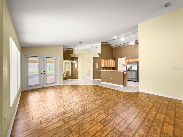 28 Golf View Dr, Ocala, FL 34472 - unfurnished living room with lofted ceiling, light wood-type flooring, french doors, a ceiling fan, and baseboards
