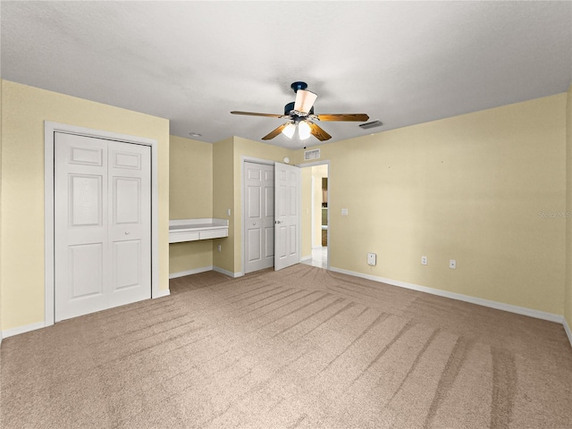 28 Golf View Dr, Ocala, FL 34472 - unfurnished bedroom with multiple closets, carpet, and baseboards