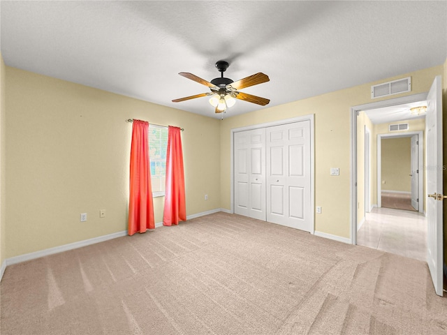 28 Golf View Dr, Ocala, FL 34472 - unfurnished bedroom featuring carpet floors, baseboards, a closet, and a ceiling fan