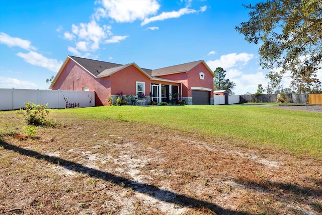 back of property with an attached garage and stucco siding