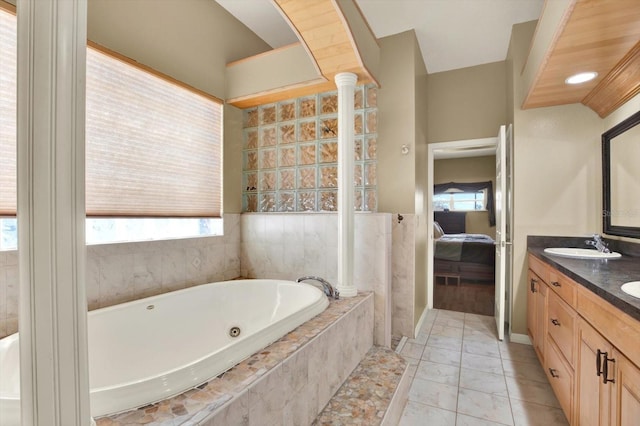 full bathroom with connected bathroom, a jetted tub, and double vanity