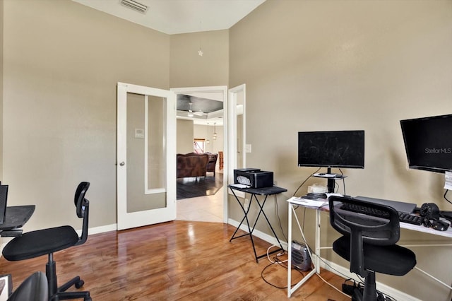 office space with french doors, wood finished floors, baseboards, and a ceiling fan
