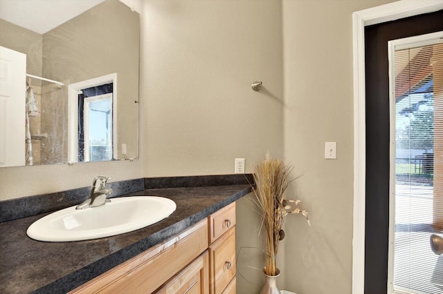 bathroom with vanity and a shower