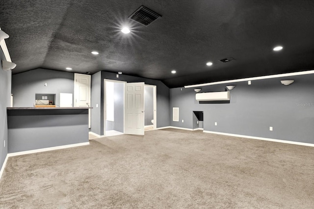 unfurnished living room featuring lofted ceiling, baseboards, carpet flooring, a textured ceiling, and recessed lighting