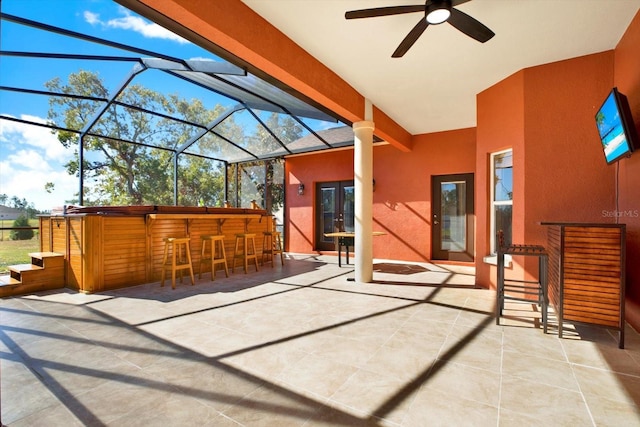 view of patio featuring a lanai and ceiling fan