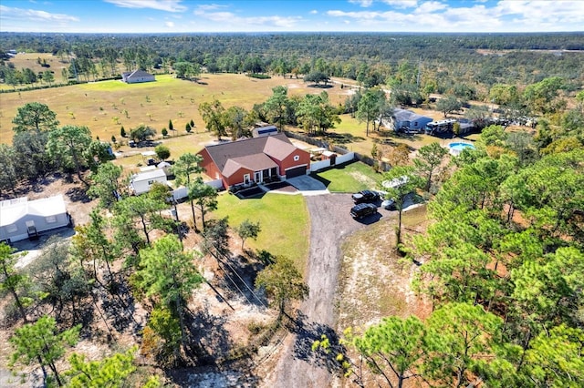 view from above of property featuring a heavily wooded area