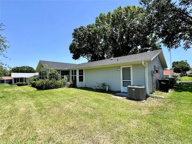 8239 SW 108th St, Ocala, FL 34481 - rear view of house featuring central air condition unit and a lawn
