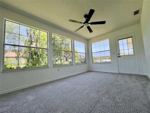 8239 SW 108th St, Ocala, FL 34481 - unfurnished sunroom featuring a textured ceiling, carpet flooring, and baseboards