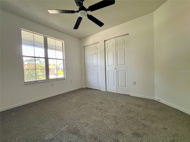 8239 SW 108th St, Ocala, FL 34481 - unfurnished bedroom with two closets, a textured ceiling, carpet floors, and baseboards