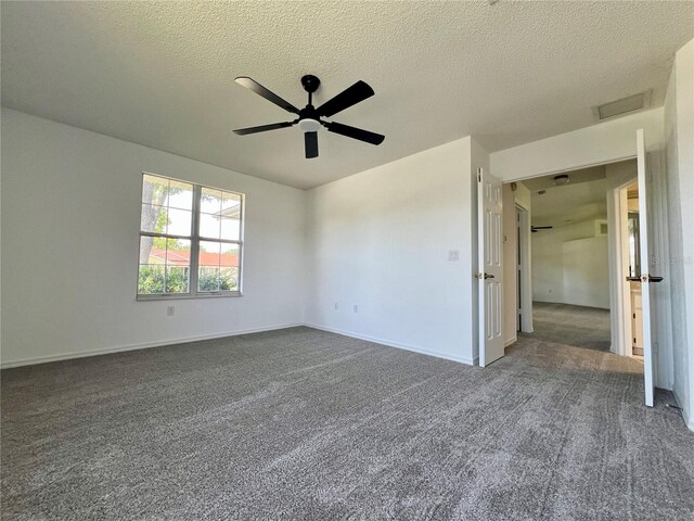 8239 SW 108th St, Ocala, FL 34481 - unfurnished bedroom featuring dark colored carpet, baseboards, ceiling fan, and a textured ceiling